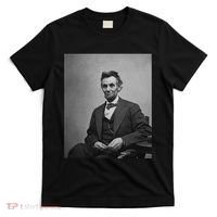 Abraham Lincoln Seated And Holding His Spectacles And A Pencil On Feb 1865 T-Shirt thumb 0