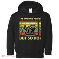 Funny The Horrors Persist But So Do Raccoon Meme Sarcastic Toddler Hoodie thumb 0