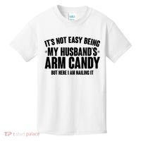 It's Not Easy Being My Husband's Arm Candy But Here I Am Nailing It Kids T-Shirt thumb 0
